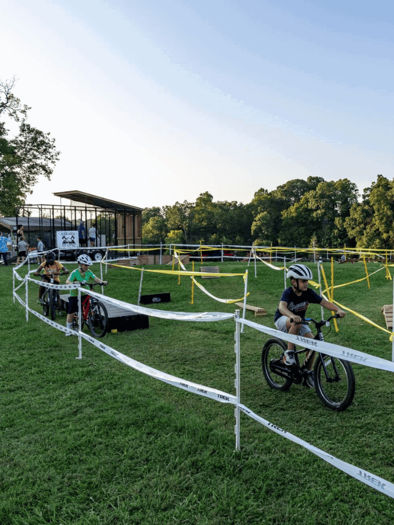 Kids mountain biking adventure at QuestForDirections outdoor event.