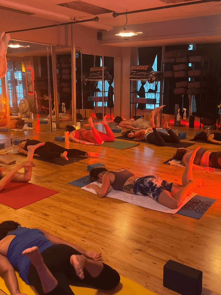 Yoga class in a wellness studio with participants practicing various poses.