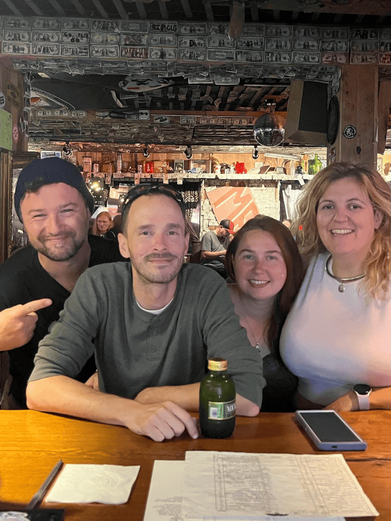 Happy group enjoying dinner at a rustic bar, capturing a fun night out with friends.