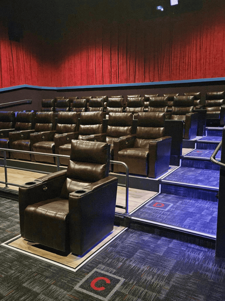 Comfortable movie theater seats with tiered viewing for an optimal cinematic experience.