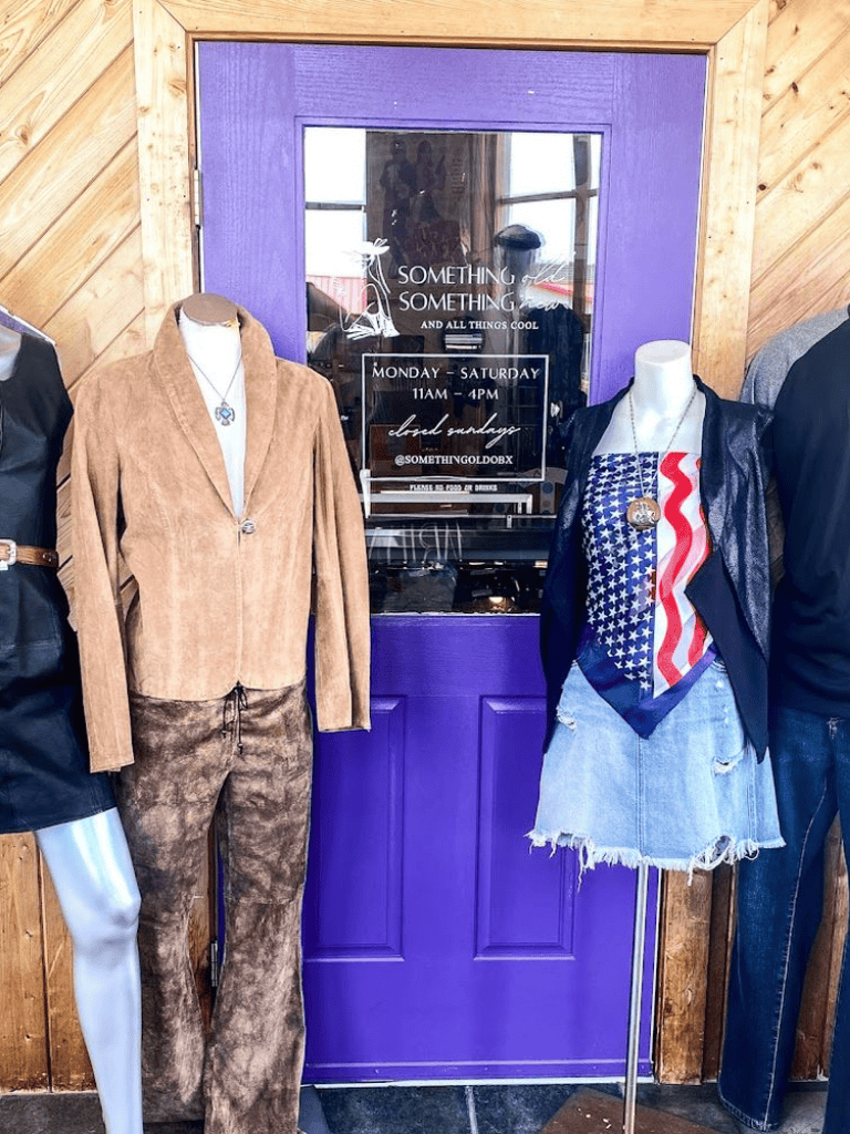 Stylish boutique clothing display at Something Gold, featuring trendy women's fashion on mannequins.