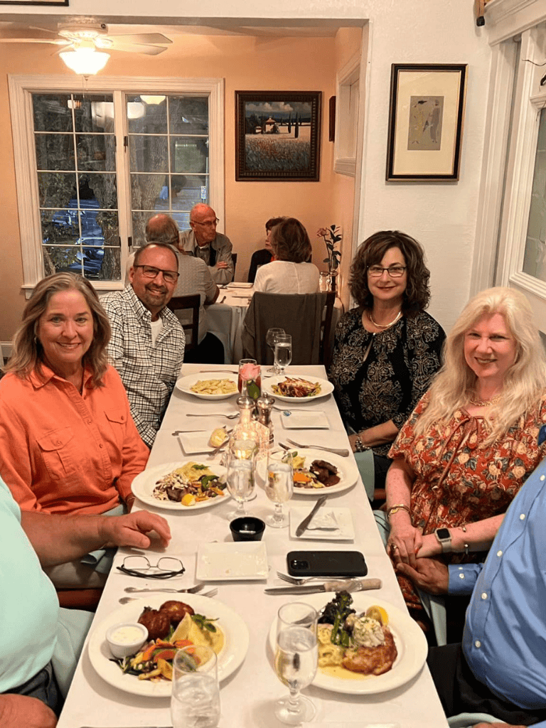 Dinner gathering of diverse professionals at QuestForDirections restaurant, showcasing engaging dining experience.