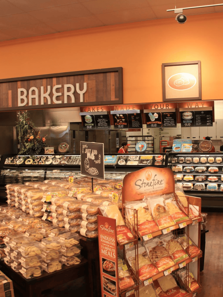 Fresh bakery bread and baked goods displayed at a grocery store bakery section.