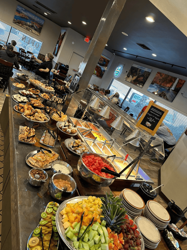 Fresh breakfast buffet with fruit, pastries, and hot dishes at QuestForDirections restaurant.