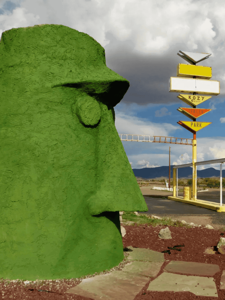 Colorful roadside sculpture of a woman's face in profile, vibrant and eye-catching.