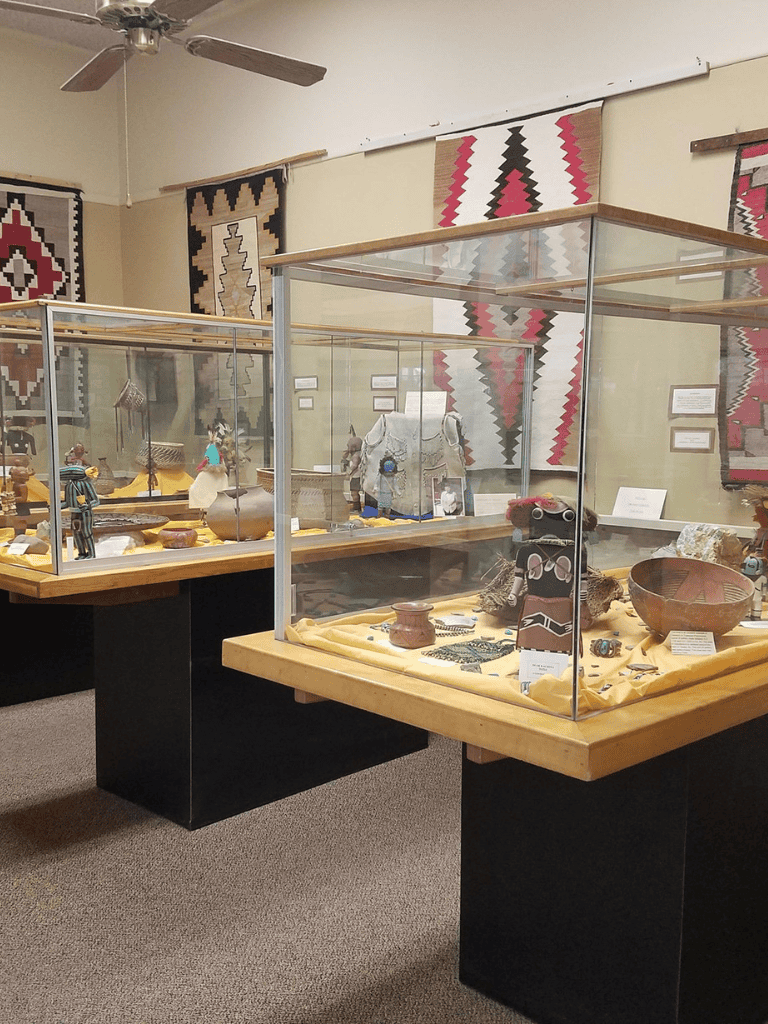 Intricate Native American artifacts displayed in glass cases at QuestForDirections museum.