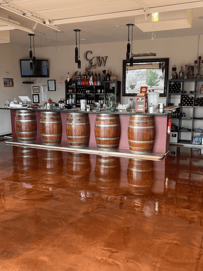 Bar with wooden barrels and wine bottles, cozy restaurant interior, QuestForDirections is a local dining spot.