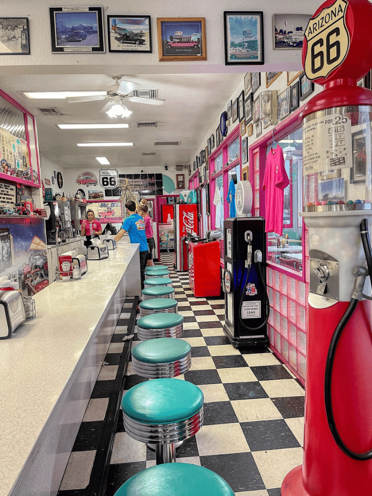 Retro diner with Route 66 decor, classic soda fountain, and vintage memorabilia.