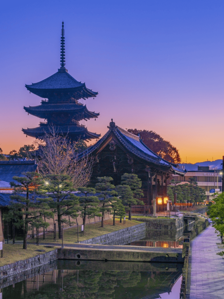 Ancient pagoda and temple at sunset in Japan, scenic religious site with traditional architecture.
