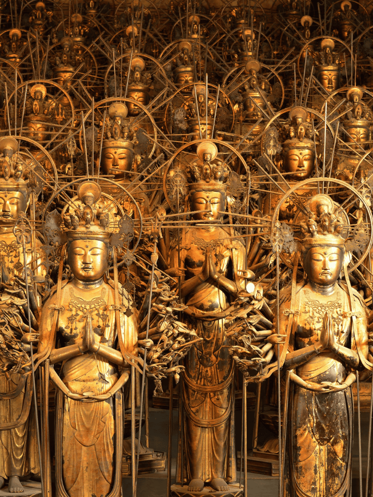 Ancient gold Buddhist statues with halos, symbolizing spiritual enlightenment and divine protection.