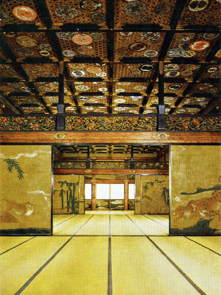 Intricate traditional Japanese room with ornate ceiling, gold painted sliding doors, and tatami mats.