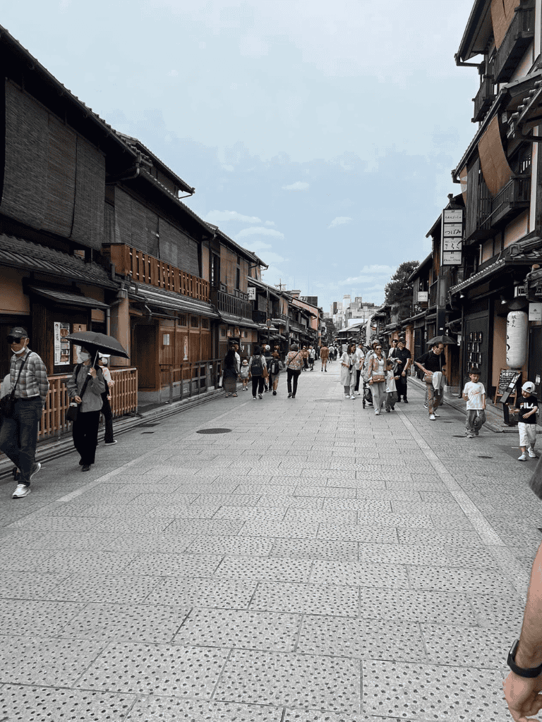 Traditional Japanese shopping street with historic architecture and visitors, perfect for travel exploration and cultural experiences.