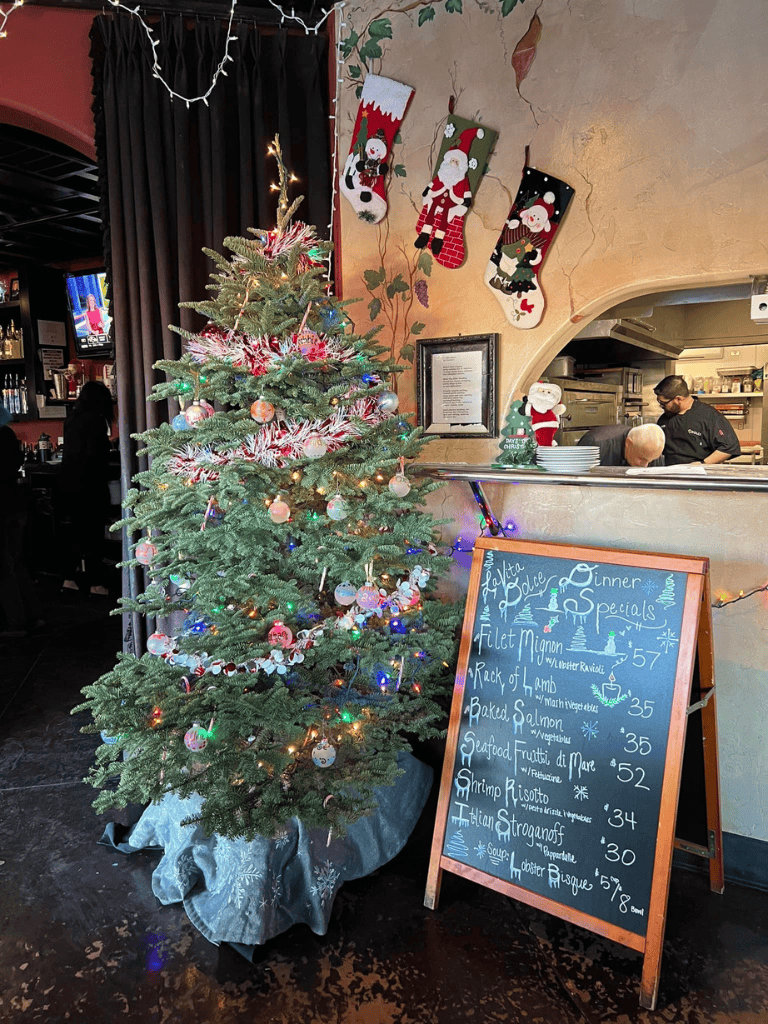 Festive decorated Christmas tree with ornaments and lights at QuestForDirections holiday restaurant.