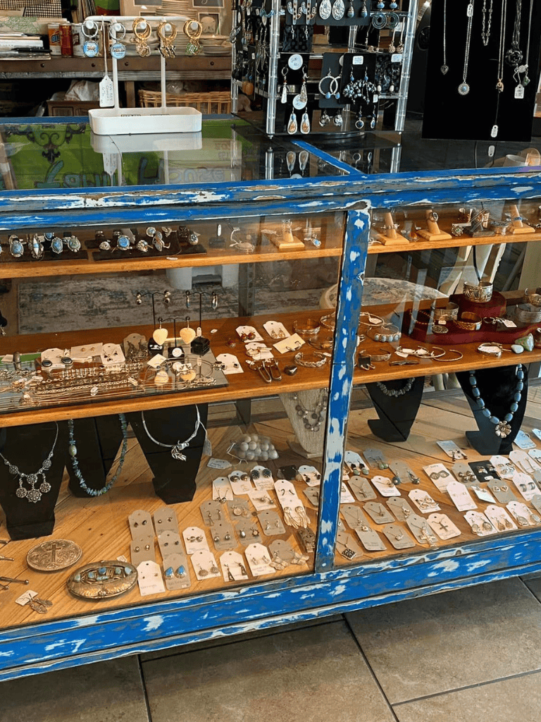Vintage jewelry display with rings, earrings, and necklaces in a boutique shop.