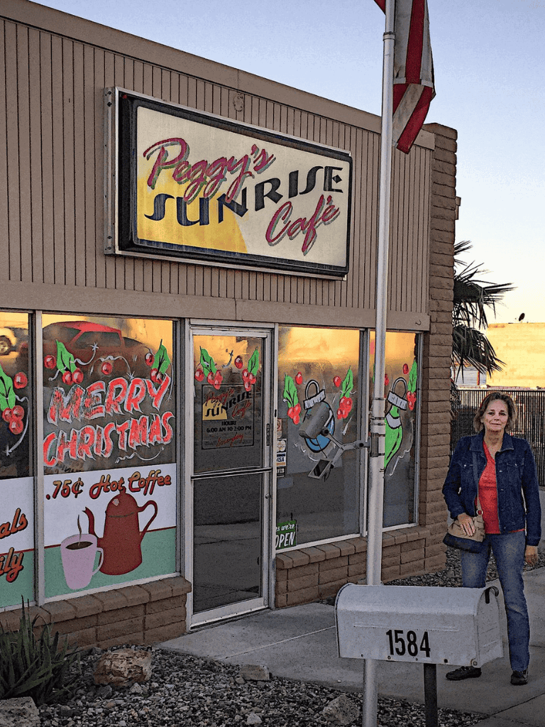 Warm cozy cafe front with Christmas decor at Peggy's Sunrise Cafe.