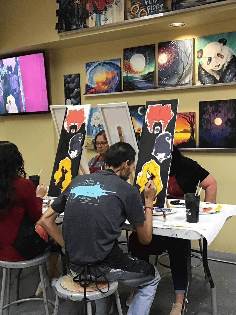 Creative painting class at QuestForDirections art studio, students creating vibrant artwork.