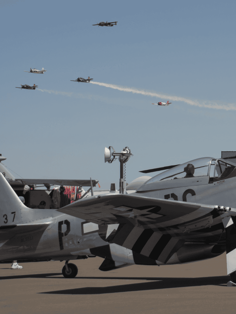 Flying vintage military aircraft and jet planes at an airshow.