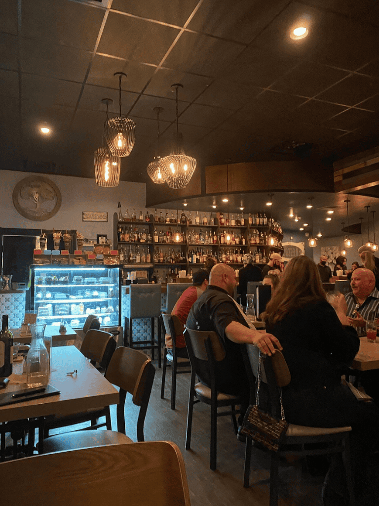 1. Cozy bar restaurant interior with warm lighting and social diners.