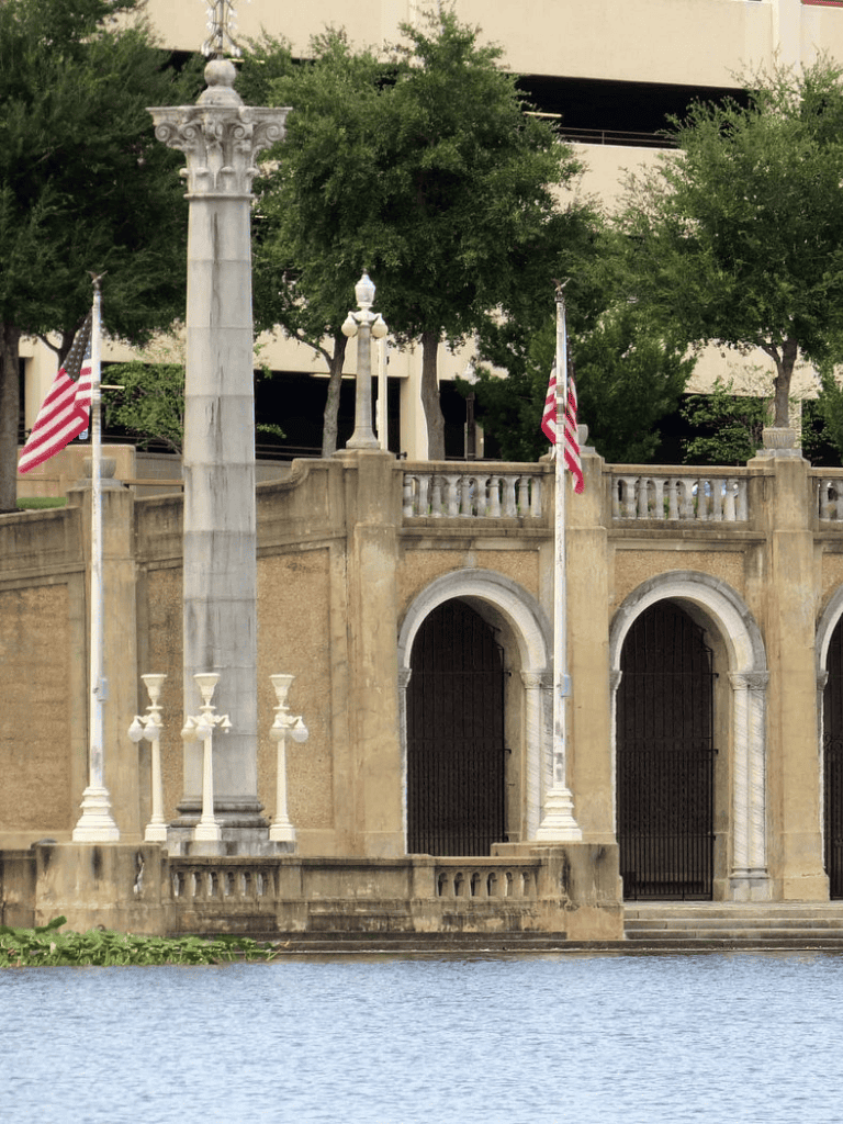 American flags at a historic waterfront monument.