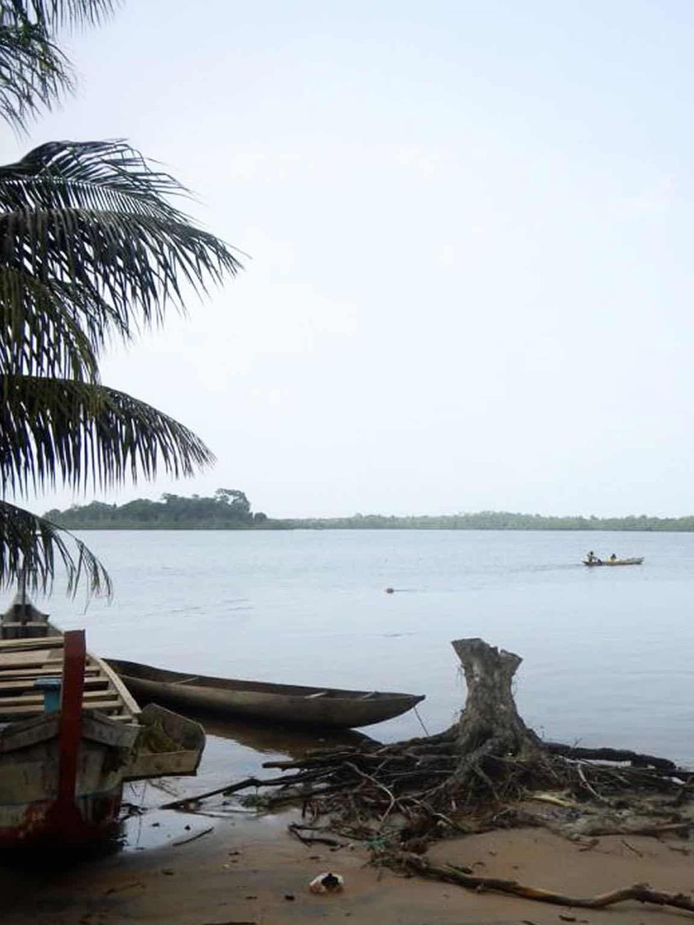 Calm river scene with boats and lush trees, showcasing tranquility and outdoor adventure with Quest for Directions.