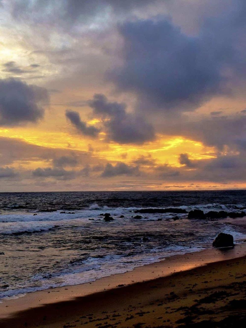 Vibrant sunset over ocean waves, perfect for beach exploration and coastal adventures.