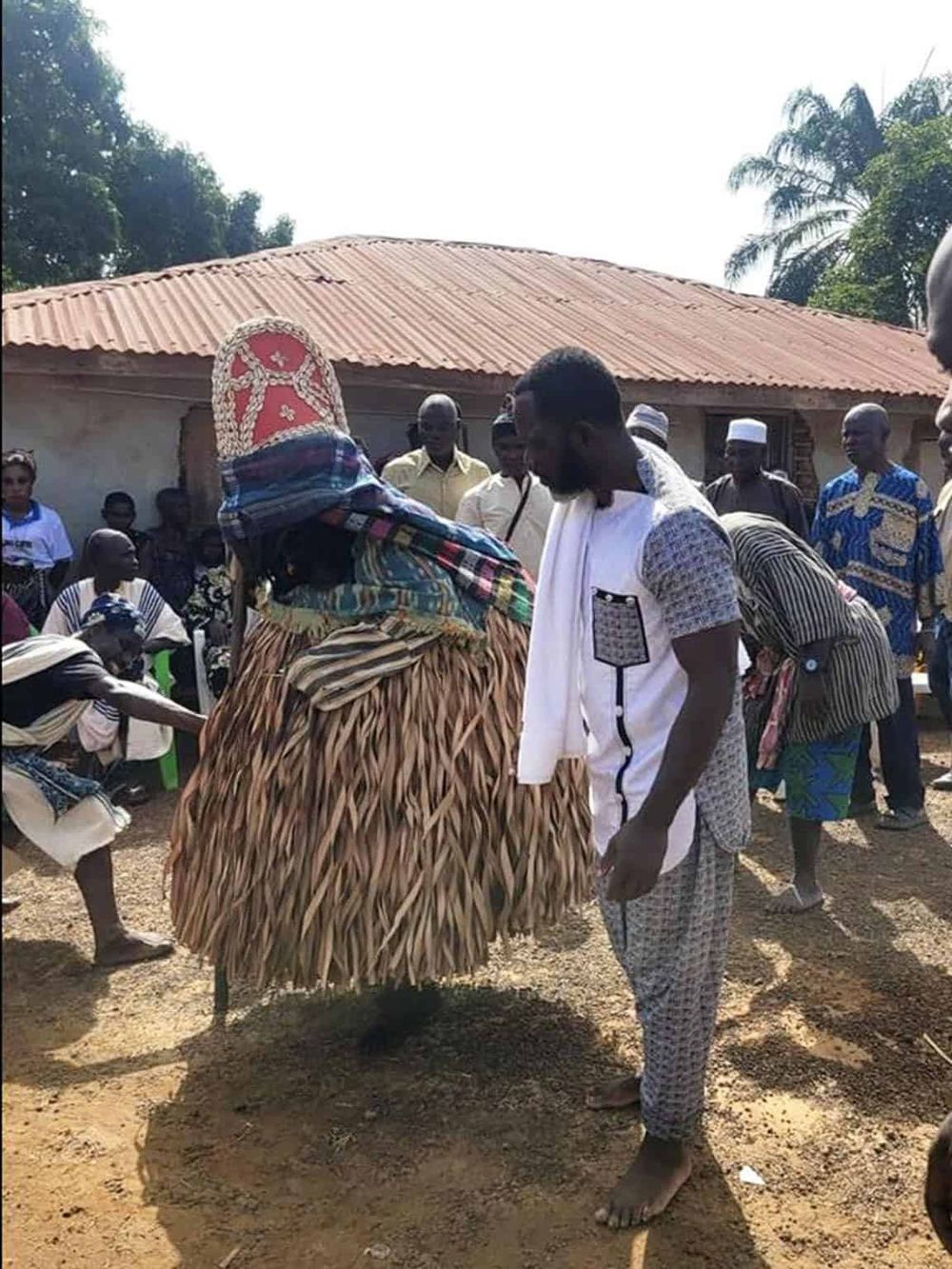 Traditional African cultural celebration with community members in colorful attire, showcasing local customs and heritage.