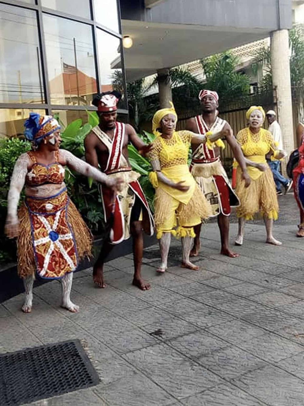 Traditional African dancers performing live street entertainment for tourists.