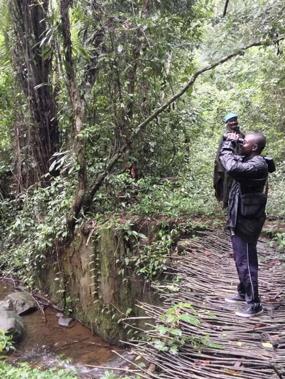 Lush jungle trail with two men enjoying nature, adventure, and exploration in a tropical forest.