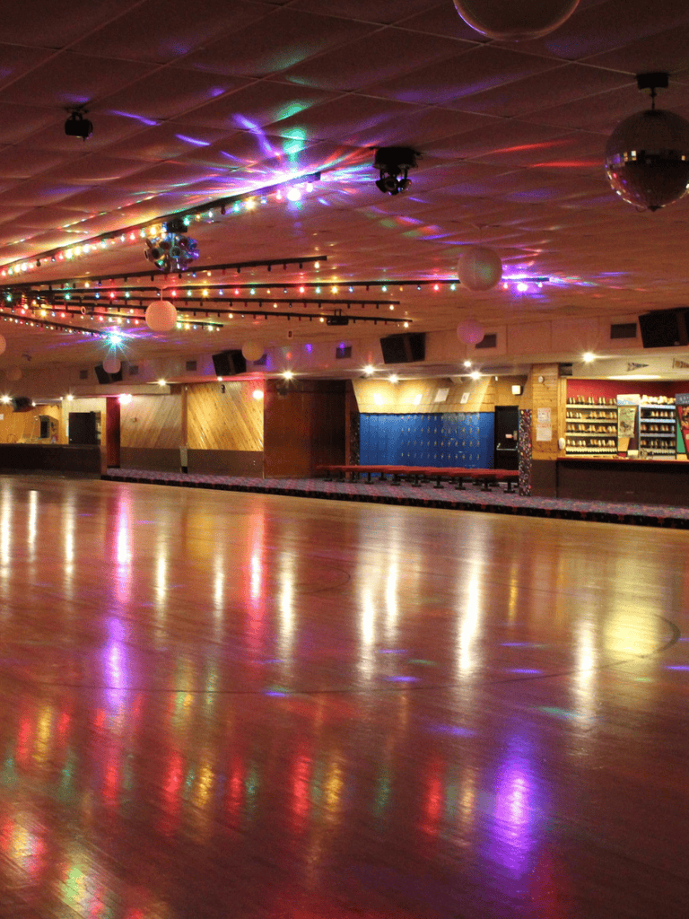 Colorful dance floor with lights and disco ball at QuestForDirections event venue.
