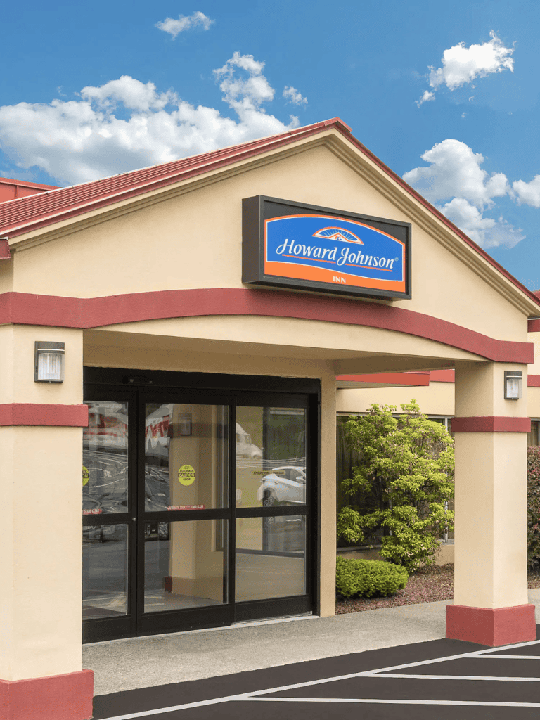 1. Howard Johnson Inn hotel entrance with clear sign and modern exterior design.