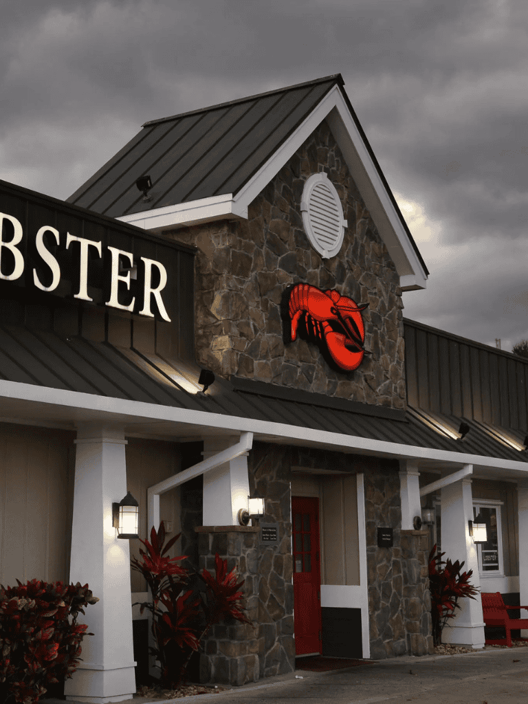 Lobster restaurant with stone facade and lobster sign in outdoor business district.