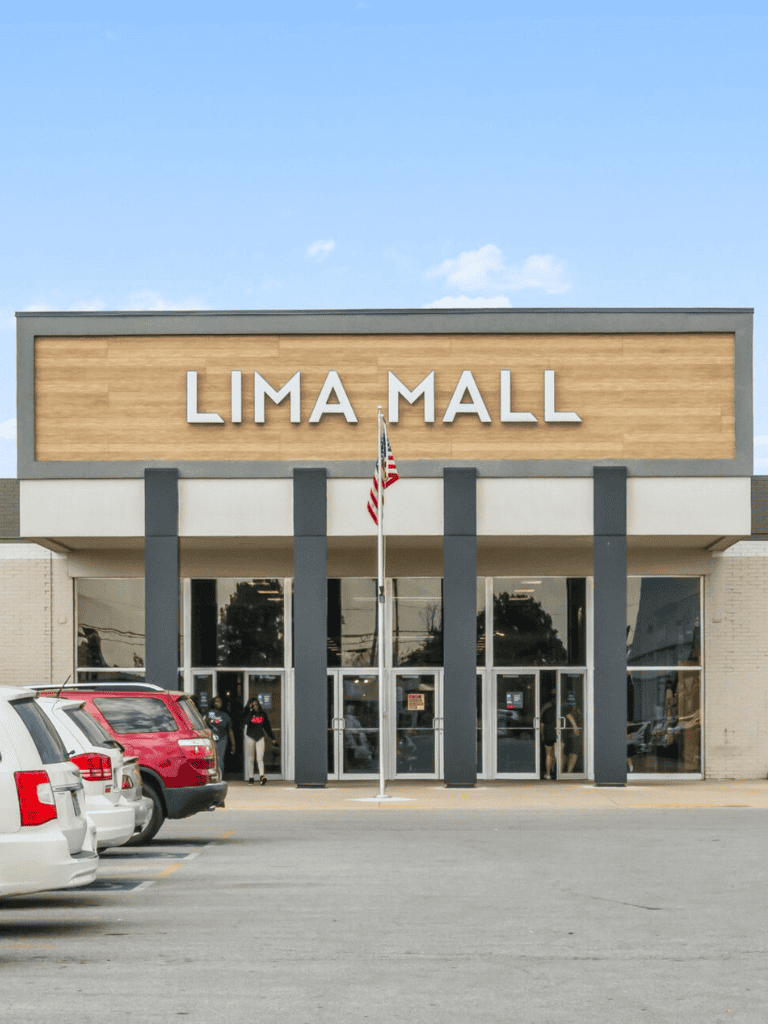 1. Modern Lima Mall storefront with parking lot and blue sky, shopping destination in QuestForDirections.