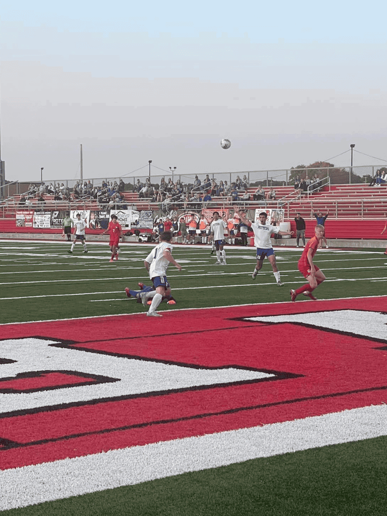 Soccer players competing on a field during a match at Quest For Directions stadium.