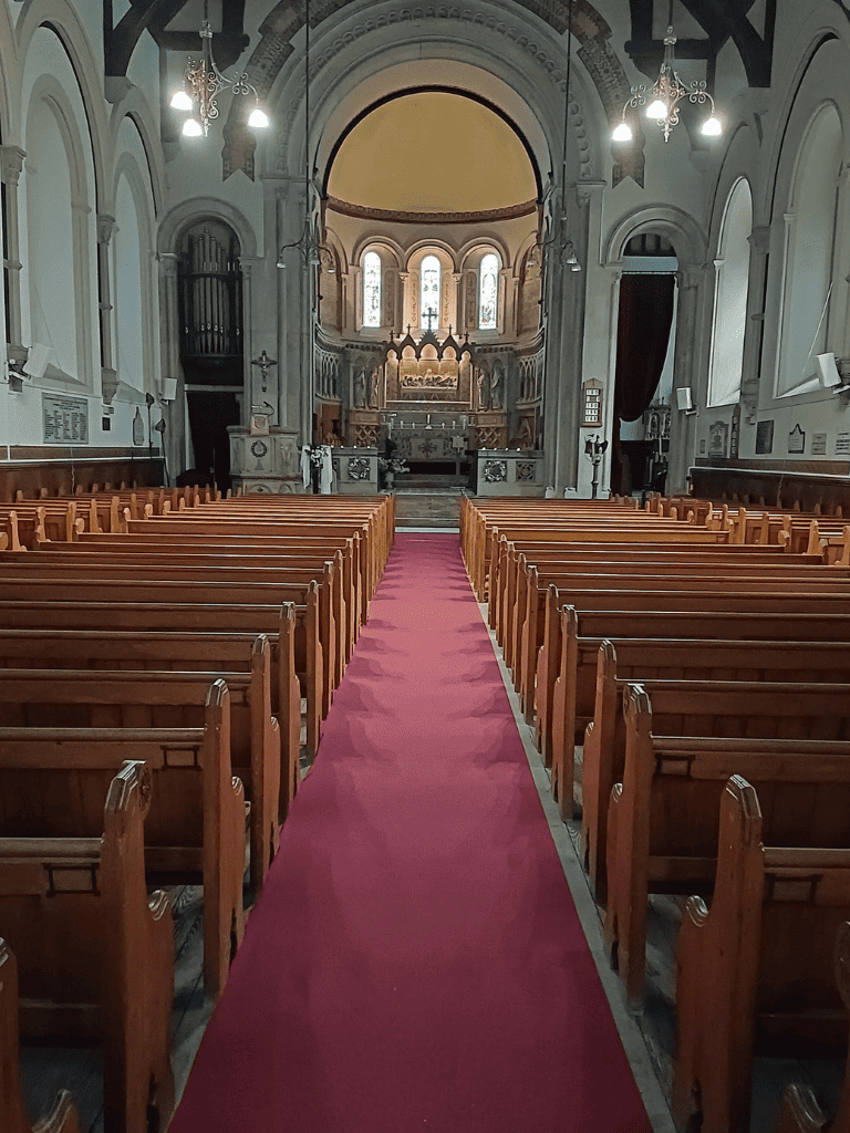 Elegant church interior with wooden pews and high vaulted ceilings for spiritual guidance.