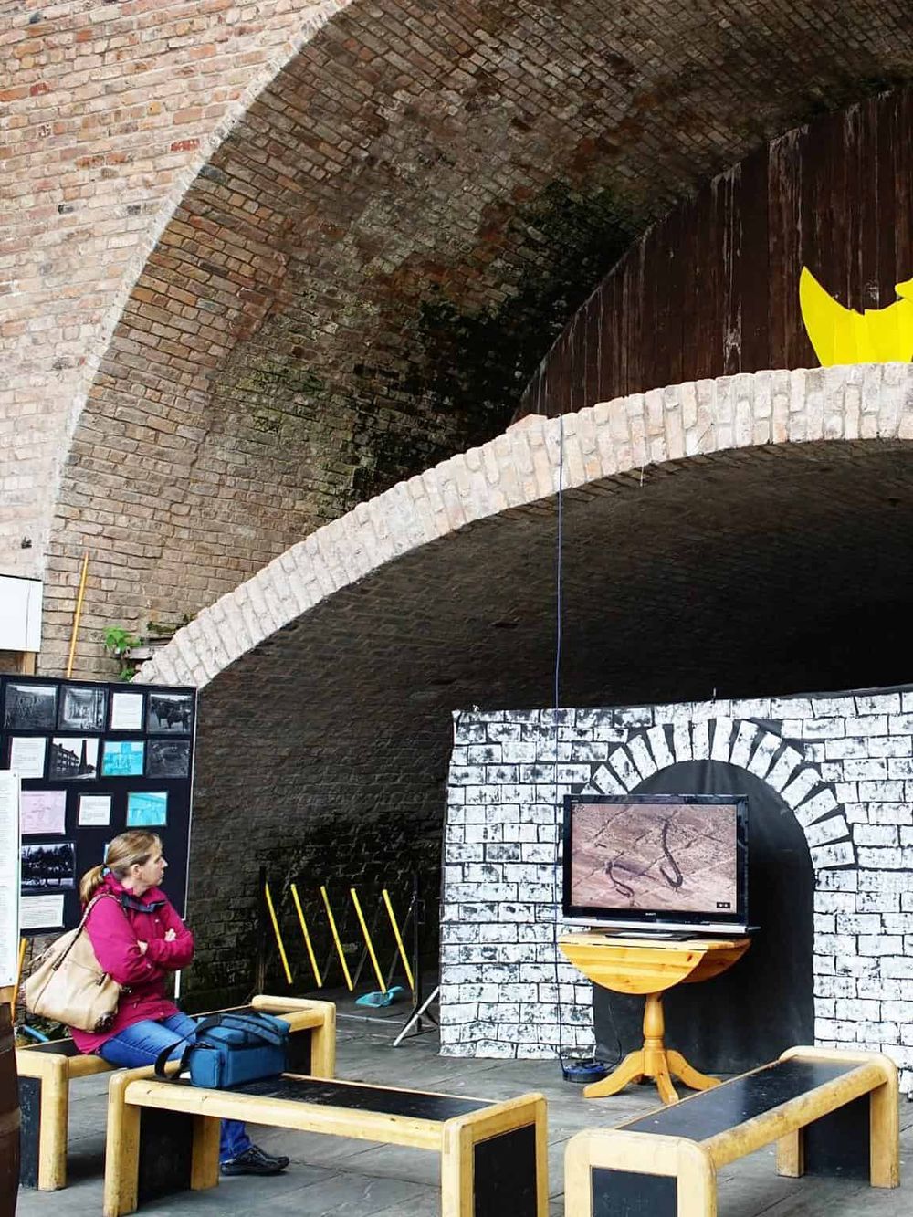 Indoor historical exhibit with brick arches and educational displays about local history.