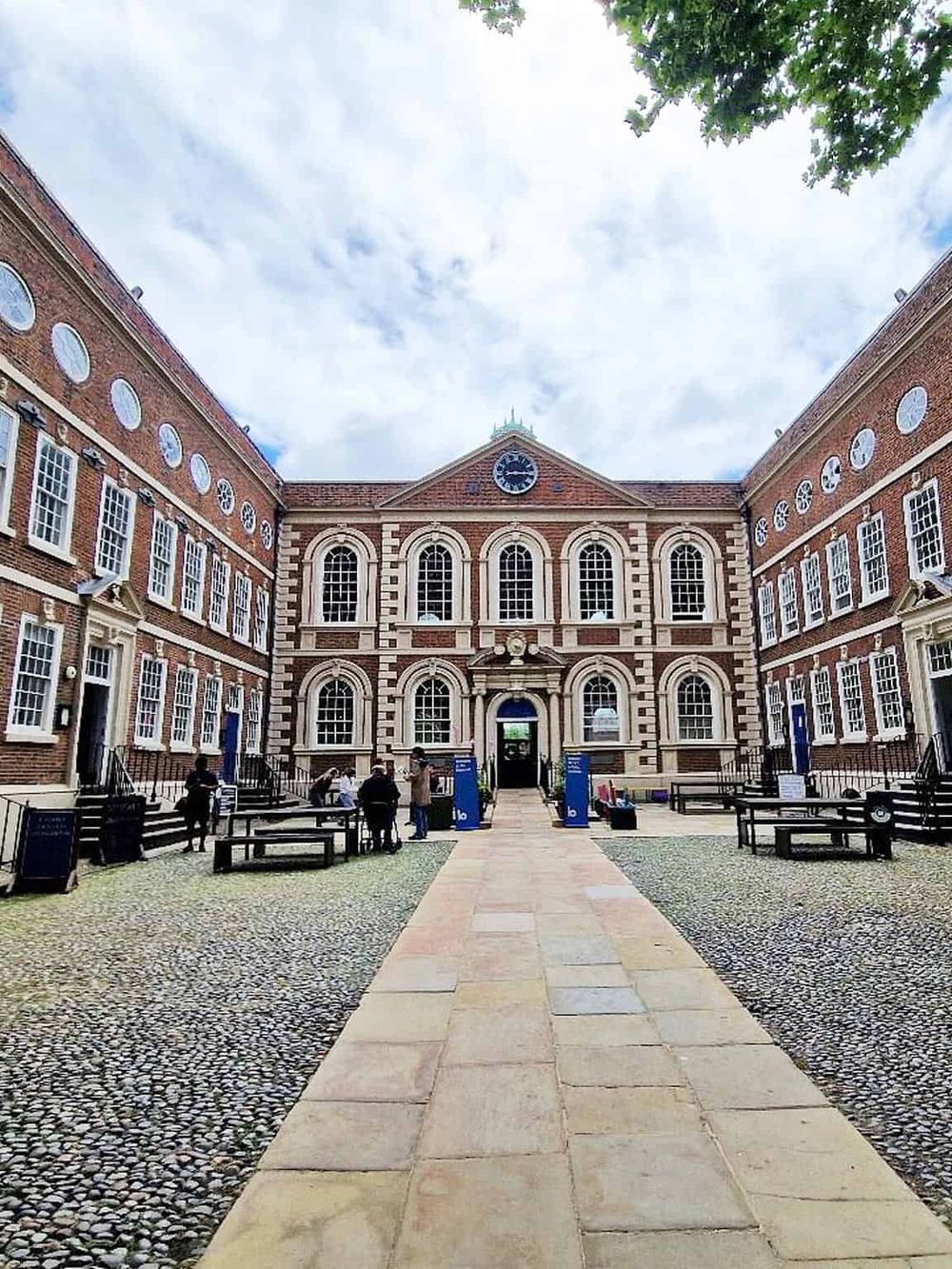 Historic building with classic architecture, large windows, and a central clock, showcasing London landmarks.