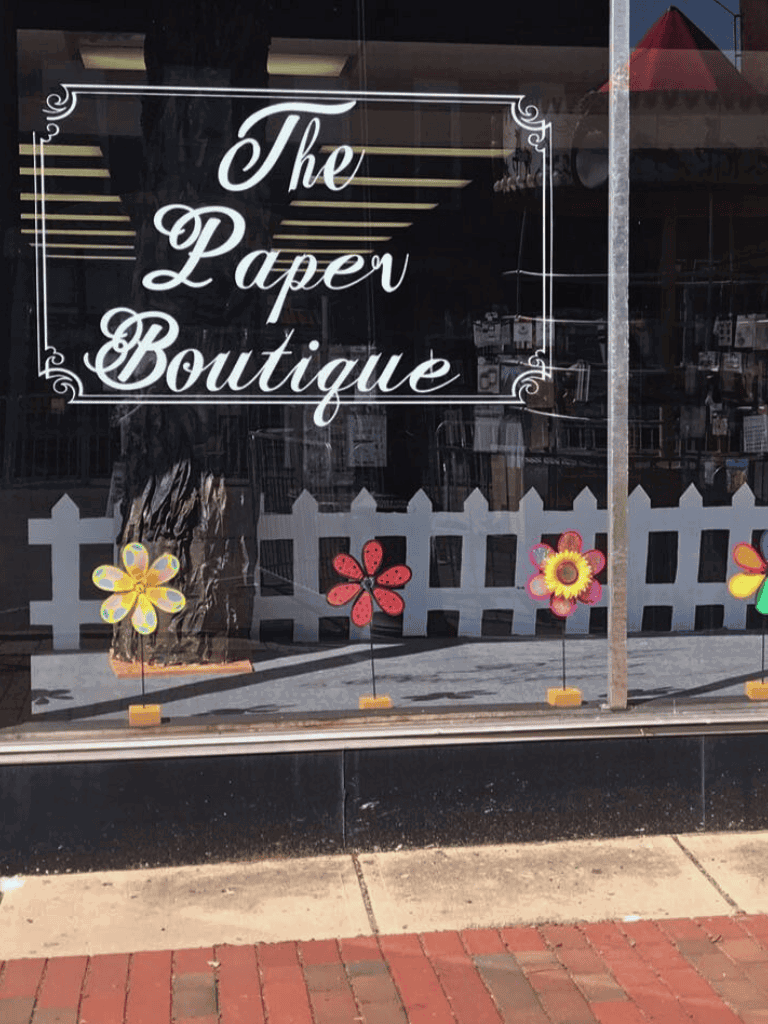 Colorful flower window decals outside The Paper Boutique store in downtown.