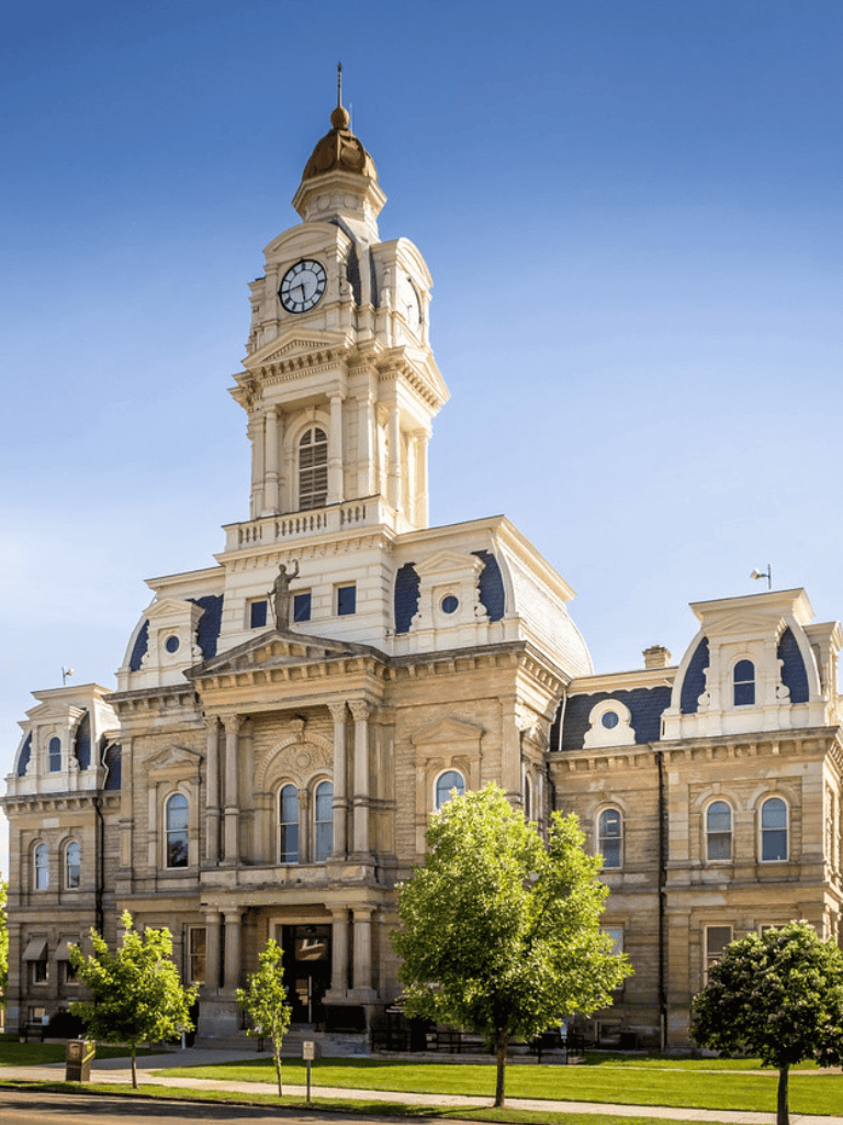 Historic courthouse building with clock tower in a cityscape, showcasing architecture and civic pride.