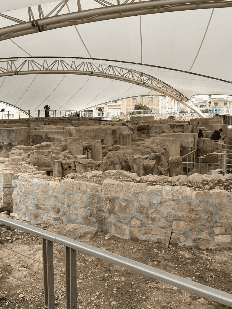 Ancient ruins under modern canopy at QuestForDirections archaeological site.