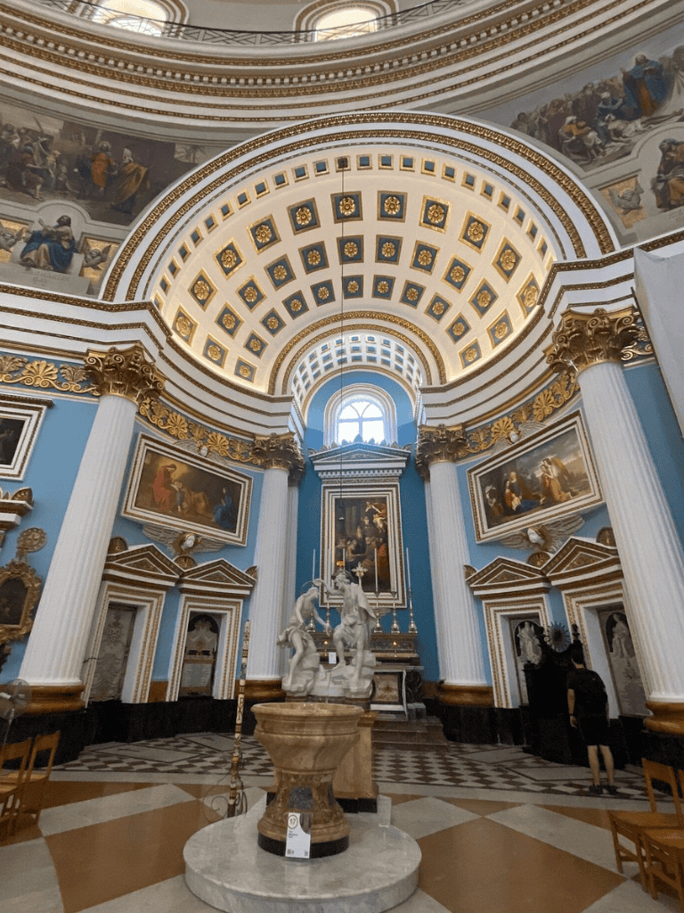 Elegant historic church interior with ornate gold accents and classical sculptures for cultural tourism.