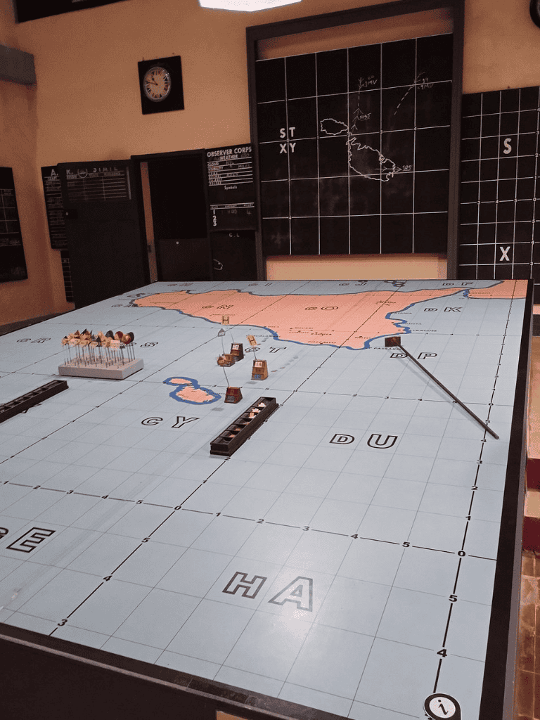 1. Battle concept board game with map and military pieces, strategic warfare gameplay in progress.