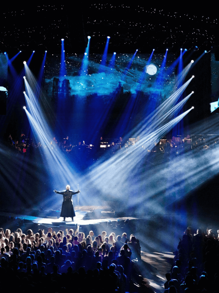 Vivid concert stage with dramatic lighting and audience engagement, highlighting immersive live event experiences.