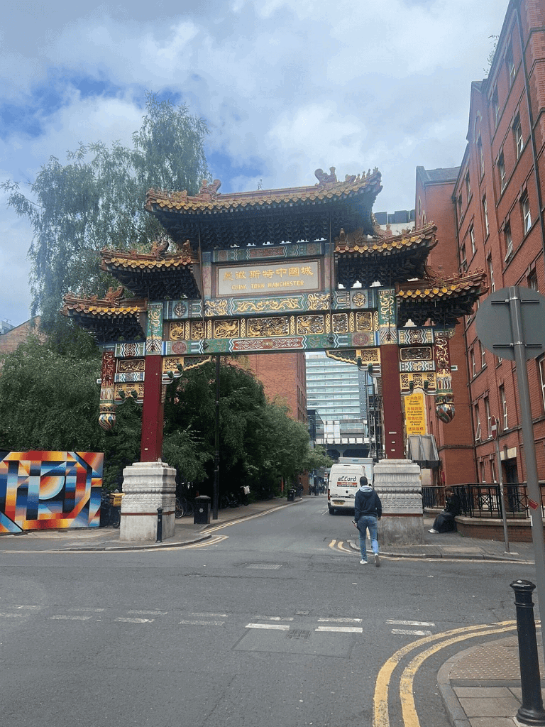Traditional Chinese archway in Manchester Chinatown with colorful decorations and intricate designs.