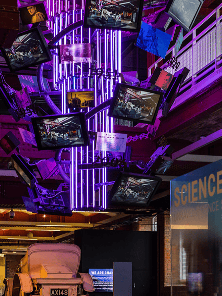 Innovative digital art installation with multiple screens and neon lighting at QuestForDirections.