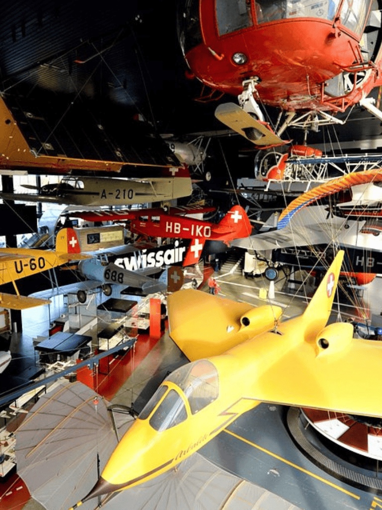 Helicopters and aircraft display at QuestForDirections museum, showcasing vintage and modern aviation models.