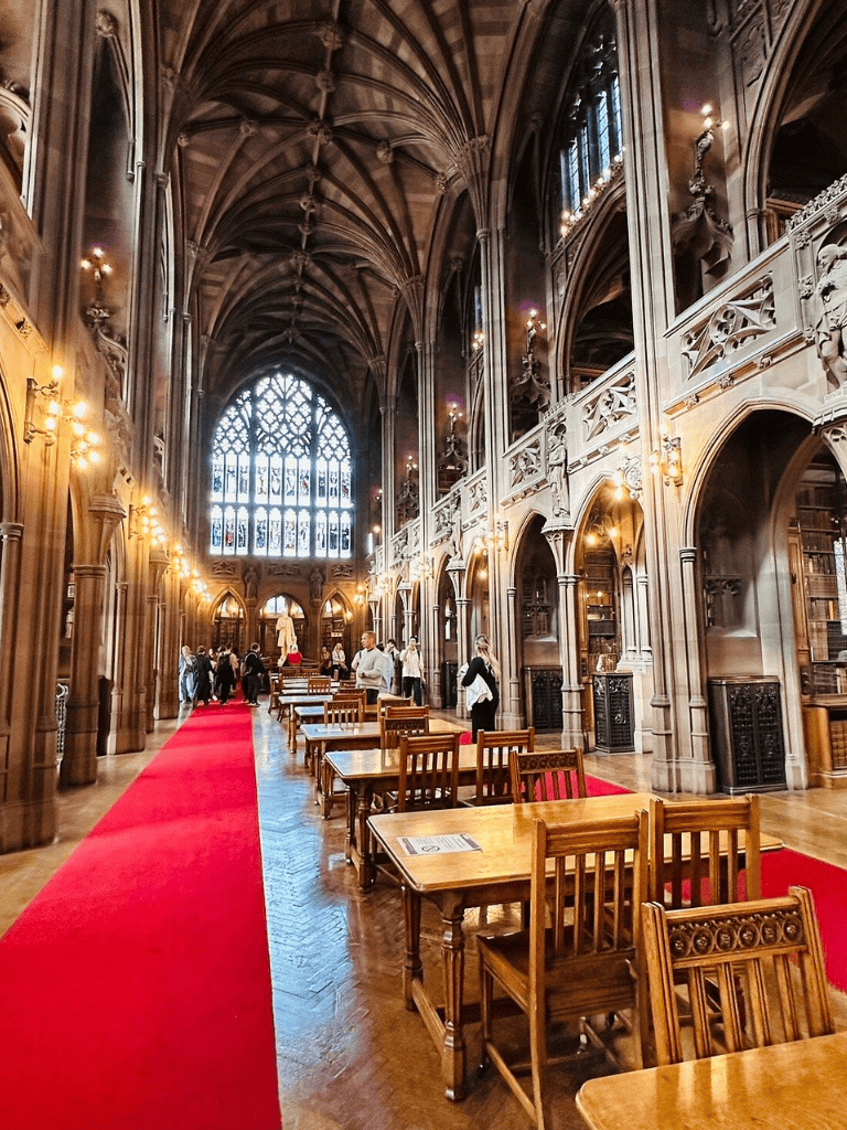 Intricate Gothic architecture in a historic library or hall with high vaulted ceilings and woodwork detailing.