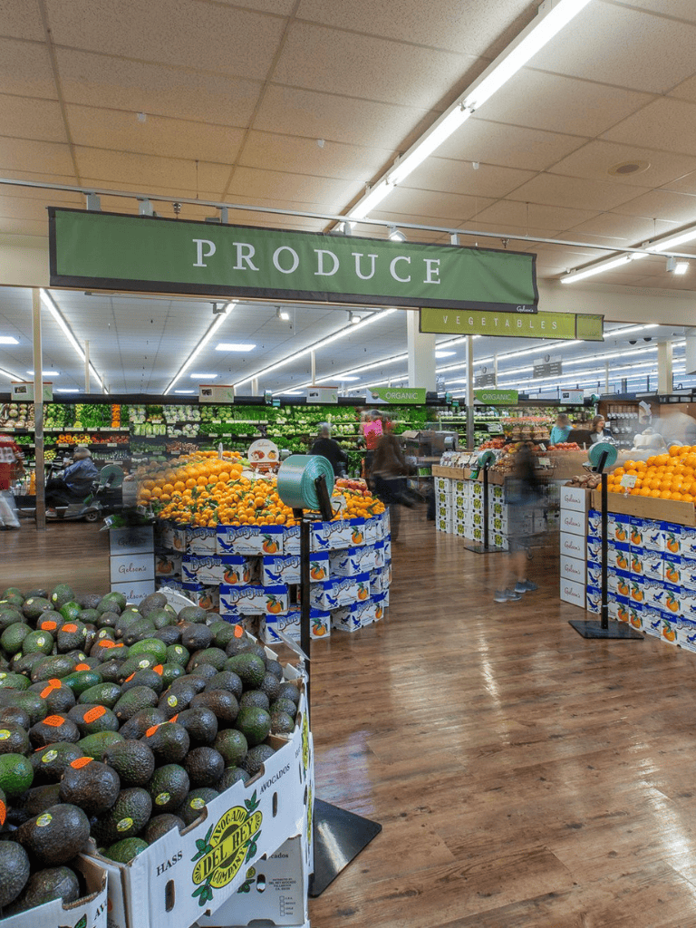 Fresh produce section at QuestForDirections grocery store with fruits and vegetables on display.