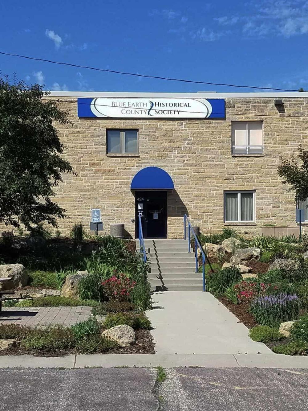 Blue Earth County Historical Society building with welcoming entrance and garden, ideal for local history visits.