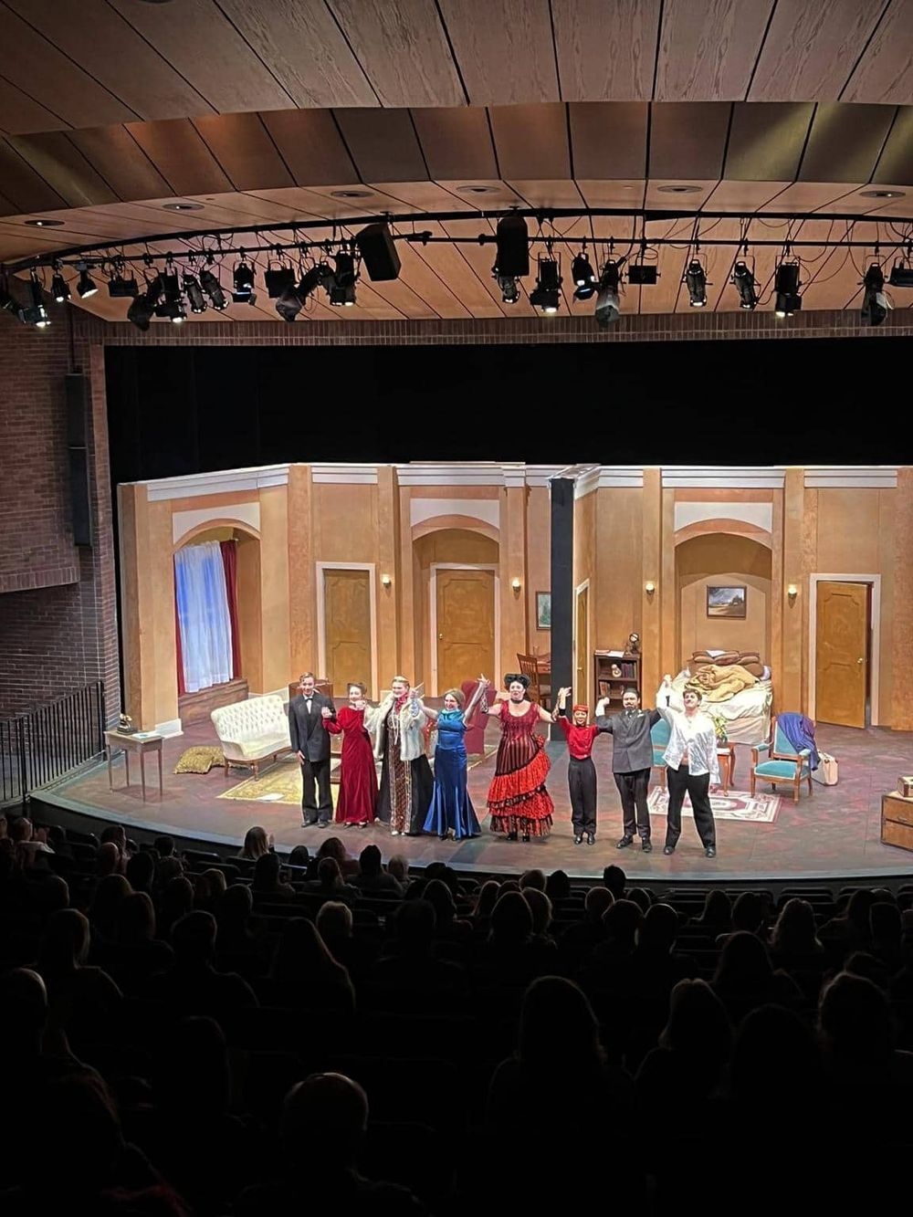 Actors performing on stage in a theatrical play.