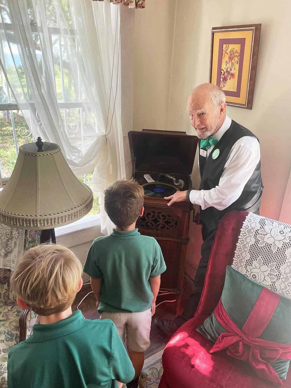 Vintage phonograph playing music for children at QuestForDirections event.